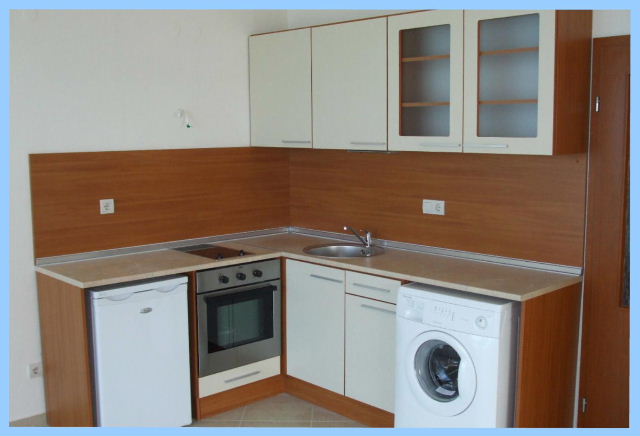 Kitchen with oven, fridge, washing machine